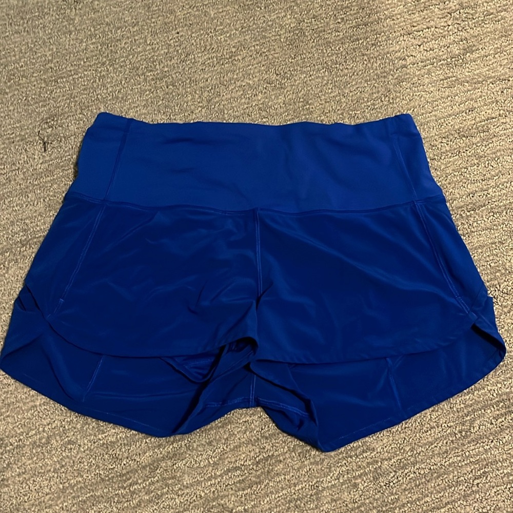 Sped up high rise short 2.5, size 8. Blue color